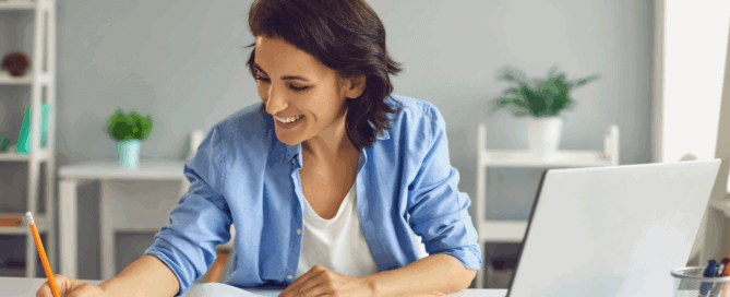 Woman smiles while looking at the finances of her small business because of cloud accounting